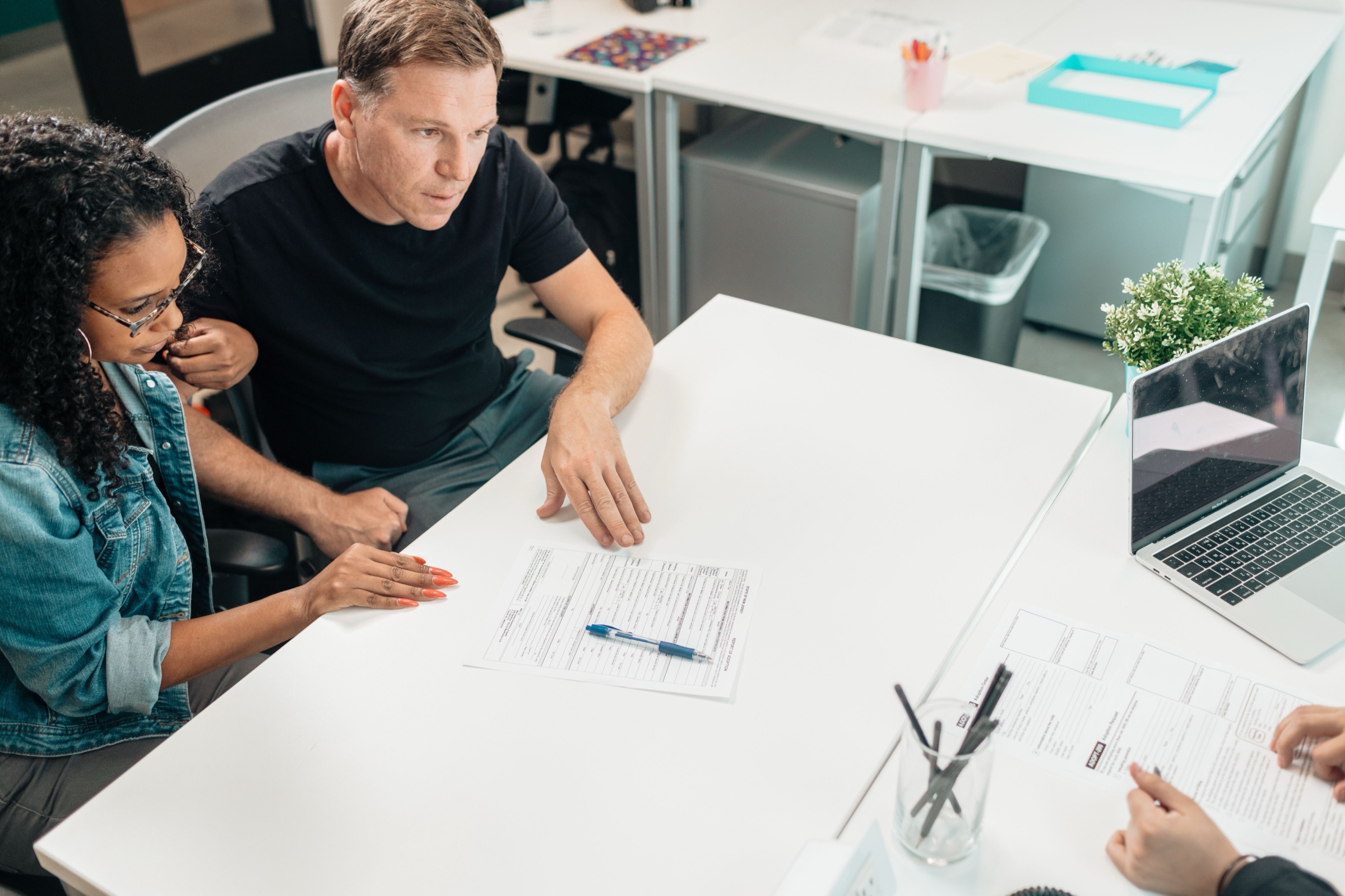 A coach and client talking across a table during a private consultation